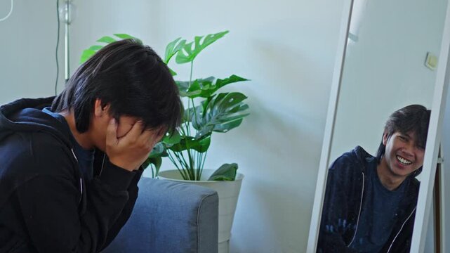Weeping man covers face while mirror reflection laughs visually capturing bipolar disorder mood extremes