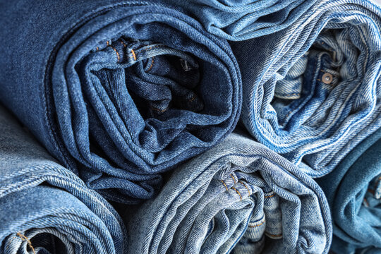 Sustainable fashion and circular economy, stack of rolled blue denim jeans textile recycling and conscious consumerism in retail