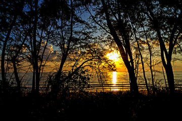 Sunrise on sea and silhouette of pnie © suthin3