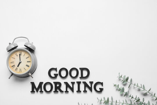 Good morning concept alarm clock with text on white background for daily routine productivity wake up time and healthy lifestyle morning habits