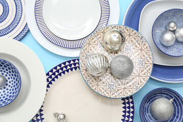 Fototapeta premium Beautiful Christmas table setting with baubles on blue background