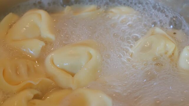 Ravioli pasta in boiling water close up 4X slow motion stock footage