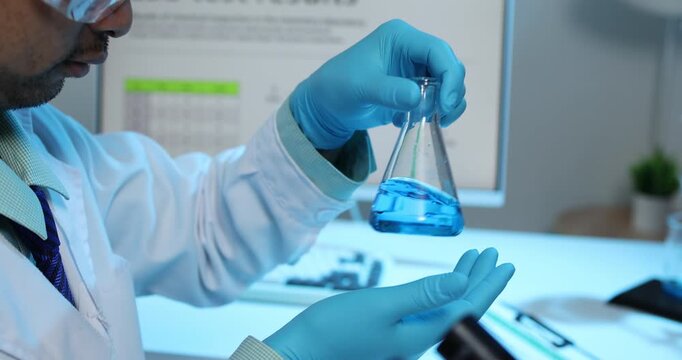 Scientific research and laboratory analysis concept featuring a researcher examining samples, performing experiments and studying test results with modern laboratory equipment.
