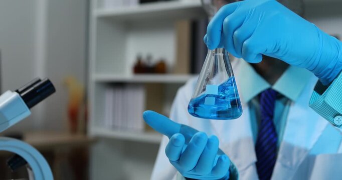 Scientific research and laboratory analysis concept featuring a researcher examining samples, performing experiments and studying test results with modern laboratory equipment.