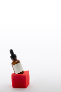 Minimalist festive still life with cosmetic serum bottle