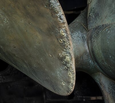 Trailing edge of drydocked bronze propeller blade with lime crust