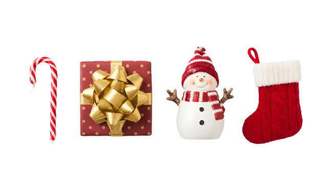Christmas elements including a candy cane, a red gift box with a gold bow, a snowman figurine, and a red stocking isolated on transparent background