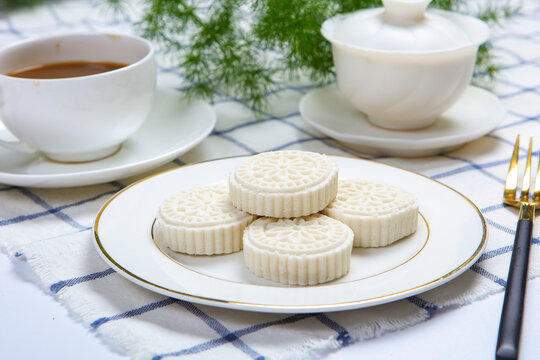 White Steamed Rice Cakes On Floral Plate With Bamboo Tea Tray
