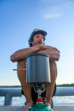 Hungry man waits for his food on a portable camp stove