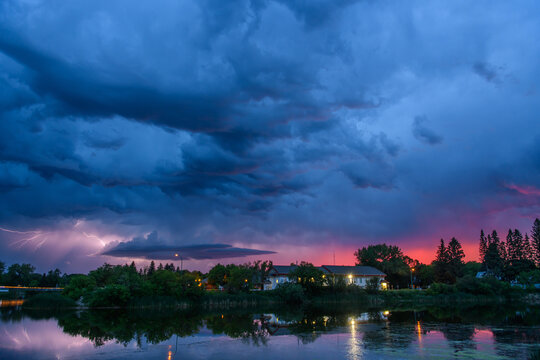 Dramatic lightning storm over a small town at dusk