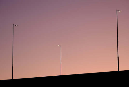 Minimalist Streetlights Against Twilight Sky
