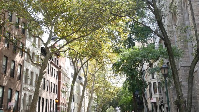 New York City urban residential buildings architecture, Manhattan classic street, Greenwich village, United States of America. Typical red brick house in NYC, real estate property in USA. West village