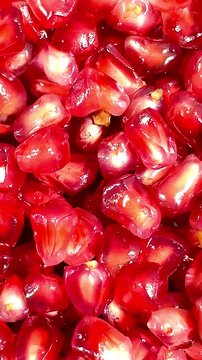 Fresh pomegranate arils glistening with natural moisture, creating a vibrant red macro texture. Juicy seeds fill the frame, highlighting the fruit&rsquo;s color, freshness, and detail up close.