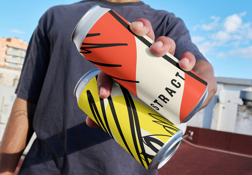 Mockup Template of Two Aluminum Cans Held in One Hand