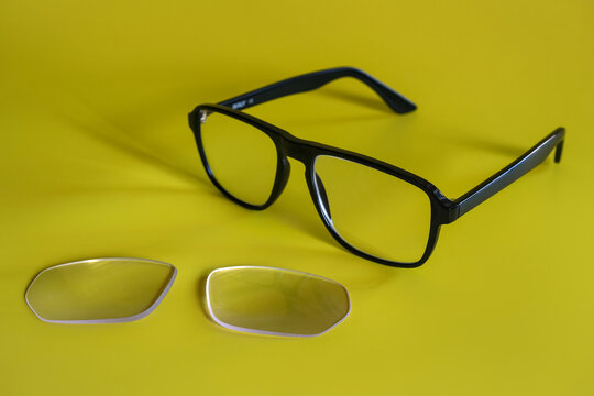 Black eyeglass frame with detached lenses, illustrating lens replacement, eyewear cost, prescription updates and insurance reimbursement.