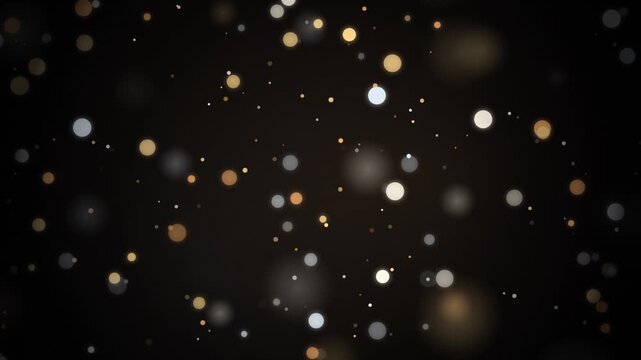 Abstract gold and silver bokeh particles floating gently on a dark atmospheric background.