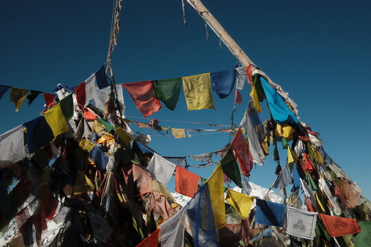 Buddhist prayer flags fluttering under blue sky in Nepal
