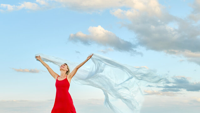 Woman holds plastic sheet outdoors promoting environmental awareness