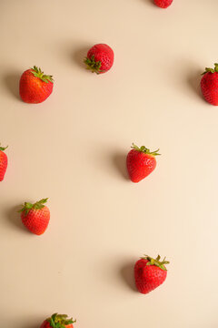 High Angle View of Fresh Ripe Strawberries Scattered on Cream Background