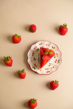 Top View Flat Lay of Strawberry Cake Slice on Decorative Plate with Fresh Berries