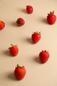 High Angle View of Fresh Ripe Strawberries Scattered on Cream Background