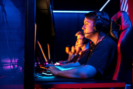 Male gamer plays online video game in an esports arena