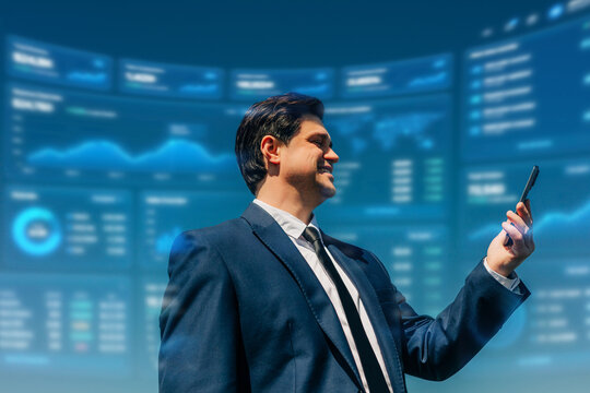 A smiling businessman checks financial data on a smartphone