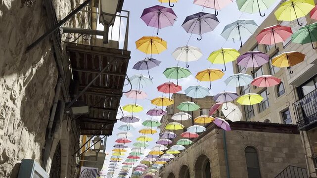 Jerusalem, Israel,  Colorful umbrellas hang above Yoel Moshe Salomon Street, a pedestrian street in the historic Nahalat Shiva neighborhood.