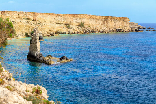 rocky shore line cliffs sea scenery view blue water texture ripple surface at the morning