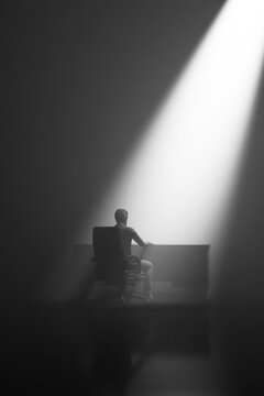 Office professional at a desk under harsh overhead scrutiny and isolation 3D