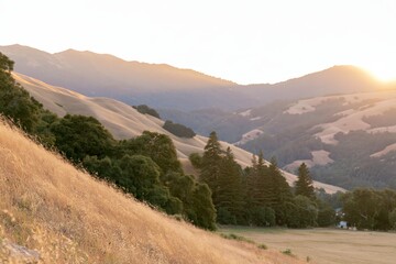 Fototapeta premium Golden Hills and Mountains at Sunset
