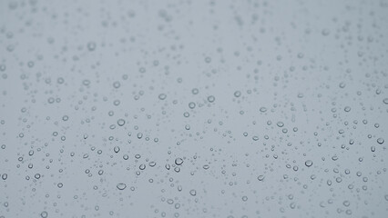 Rain drop hitting window glass and sliding down © GCapture