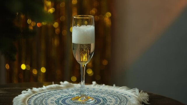 Celebrating New Year. Woman pouring glass of champagne and drinking it at New Year party.
