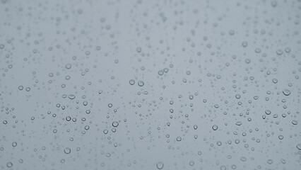Rain drop hitting window glass and sliding down © GCapture