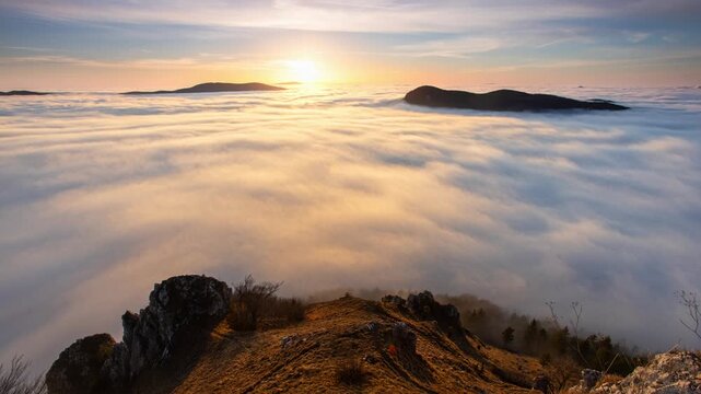 Time lapse above clouds of sunset in a Carpathian mountain valley with wonderful gold light on a hills
