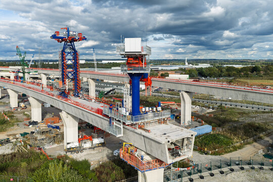 Aerial view of high speed rail construction featuring concrete pillars and a large launching gantry in the United Kingdom.