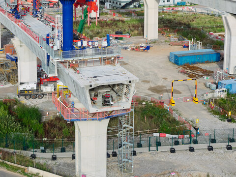 Aerial view of high speed rail construction site featuring concrete bridge segments and support pillars in the United Kingdom.