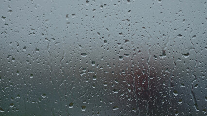 Rain drop hitting window glass and sliding down © GCapture