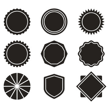 Collection of nine black silhouette badge and emblem shapes on a white background