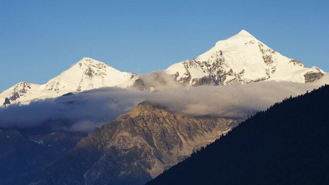 Time lapse of sunset view to Tetnuldi peak. Mountain panorama landscape of Upper Svaneti, Georgia, Europe. Caucasus mountains