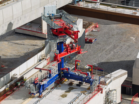 Aerial view of High Speed Rail Construction featuring a large red and blue bridge launching gantry on a concrete viaduct in the United Kingdom.