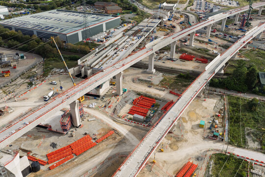 Aerial view of high speed rail construction site featuring concrete viaduct pillars and elevated tracks under development in the United Kingdom.