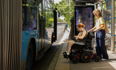 Woman in electric wheelchair waiting for public bus © PintoArt