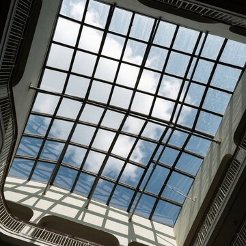 Skylight glass roof with grid structure and clouds