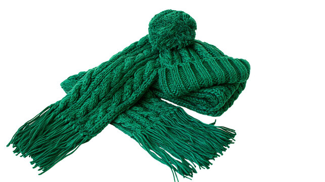 Isolated cozy green knitted winter hat with a soft pompom and matching cable knit scarf set