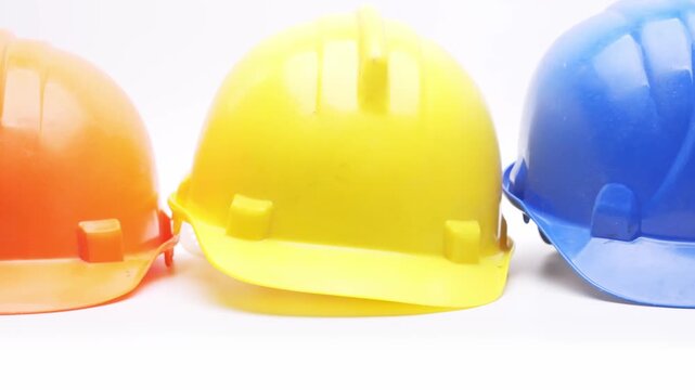 Construction Safety Helmets In Orange Yellow Blue and white On White Background