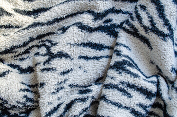 Textured fabric with a black and white striped pattern in a close-up view © Володимир Виповський