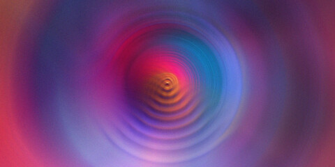 Vibrant rainbow color circles with radial motion blur create dynamic hypnotic swirl effect. © Sankor