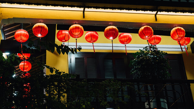 Traditional Red Lanterns on Yellow Building at Night in Hoi An, Vietnam