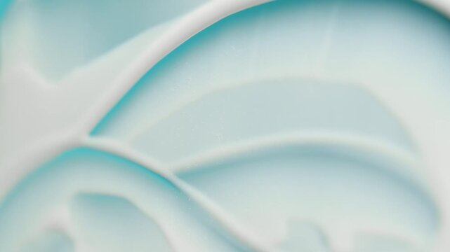 Close up of a cosmetic blue cream being smeared with a spatula for a skin care advertisement showing its perfect texture